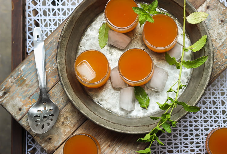 A glass of Wood Apple Juice served on a wooden tray