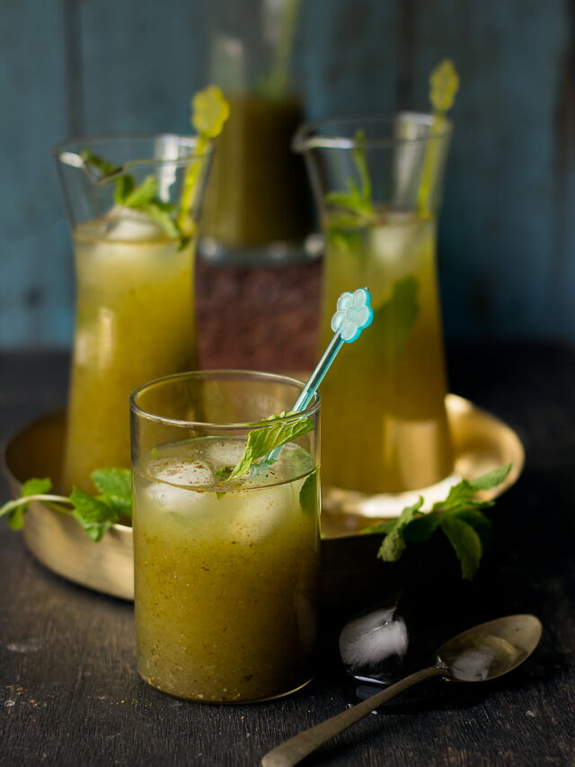 Refreshing glass of Aam Panna served with ice and garnished with fresh mint leaves