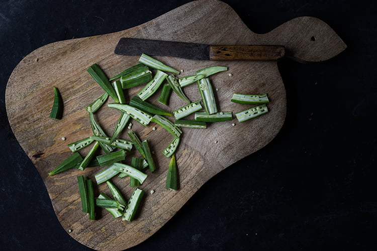 Slicing fresh bhindi to make besan bhindi masala