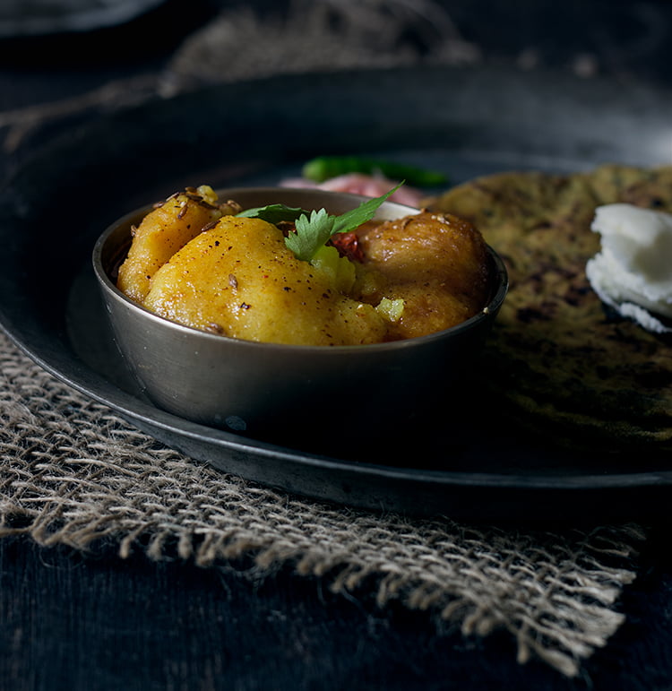 Final dish served in a traditional bowl with roti