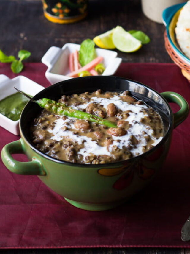Close-up shot of rich and velvety Dal Makhani served with naan