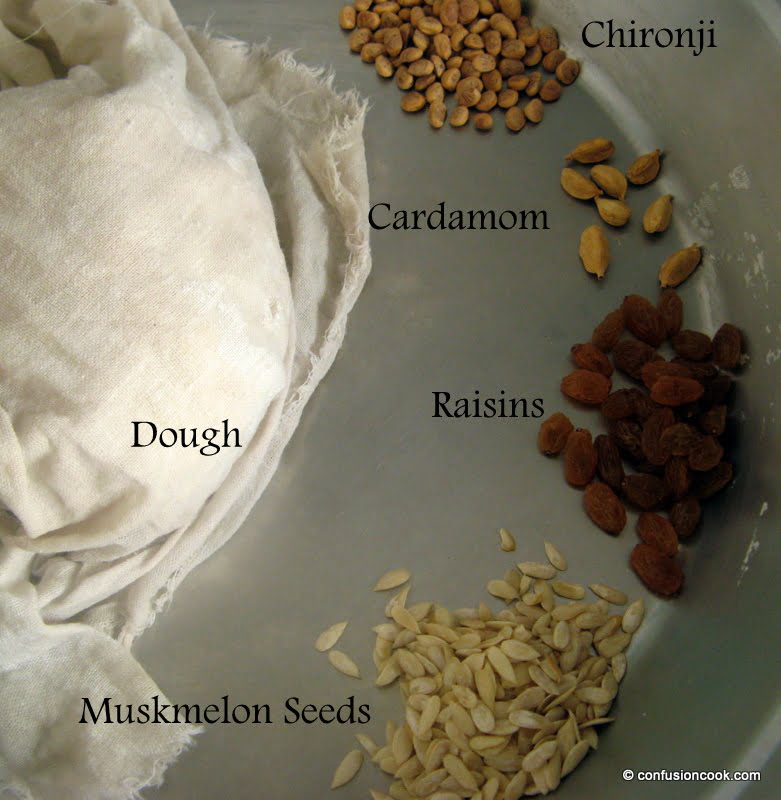 Ingredients for Gujiya Recipe: flour, khoya, sugar, cardamom, and dry fruits laid out on a kitchen counter