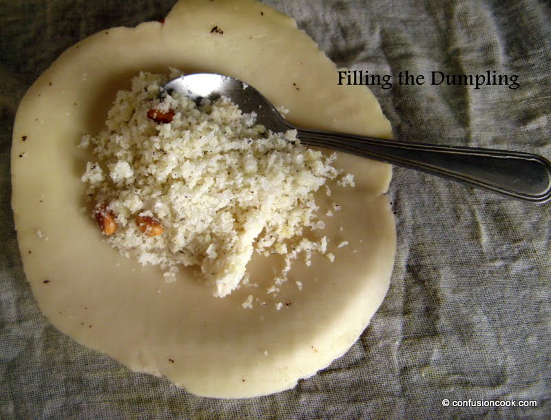 Filling Gujiya with sweet khoya mixture and folding them into crescent shapes