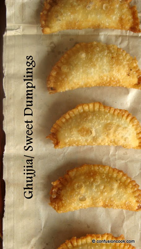 Freshly fried Karanji with crispy edges and a glossy finish, placed on a festive tray