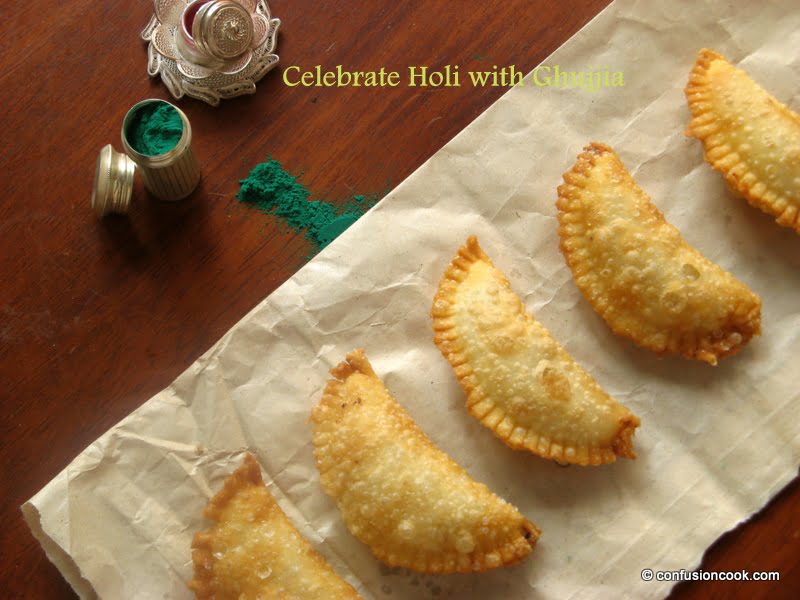 A close-up of the perfectly fried Karanji draining on a paper towel