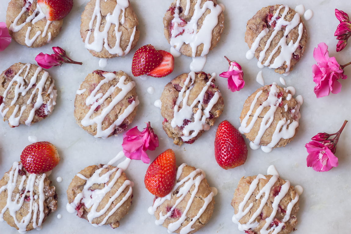 A close-up of a baked scone showing chunks of strawberries inside
