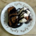 Close-up of fudgy chocolate brownie cake with glossy top.