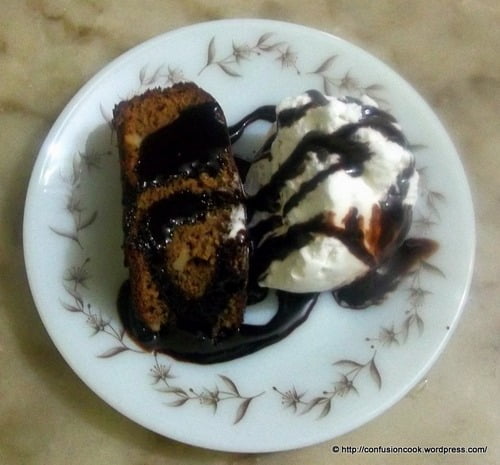 Close-up of fudgy chocolate brownie cake with glossy top.