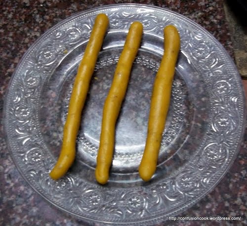 Gatte (besan dumplings) being rolled into cylindrical shapes