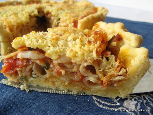 A slice of Pasta Tart, highlighting the rich and creamy filling