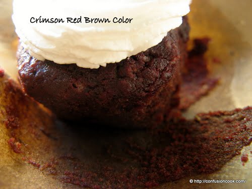 Overhead view of red velvet cupcakes with decorative frosting.