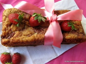 Eggless strawberry pound cake topped with fresh strawberries
