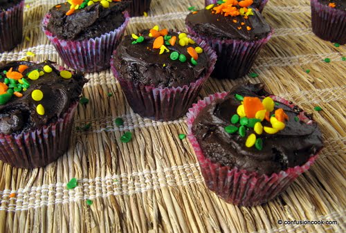 Close-up of a chocolate cupcake topped with colorful sprinkles