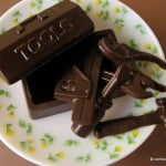 Homemade chocolate bars in geometric molds on a cooling rack