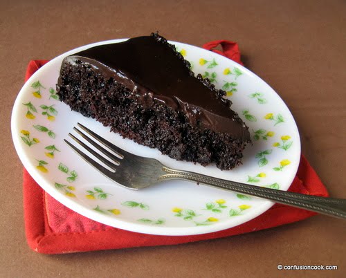 A beautifully plated slice of Sachertorte with a drizzle of chocolate sauce