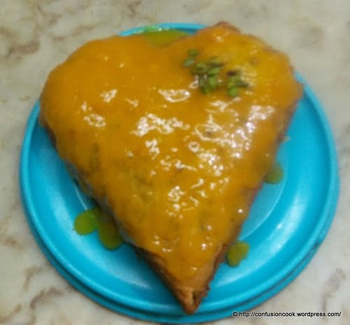 Eggless mango cake topped with mango sauce