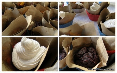 Close-up of moist red velvet cupcake topped with swirled frosting.