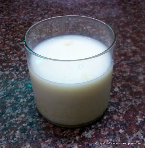 Homemade Thandai poured into glasses topped with chopped dry fruits