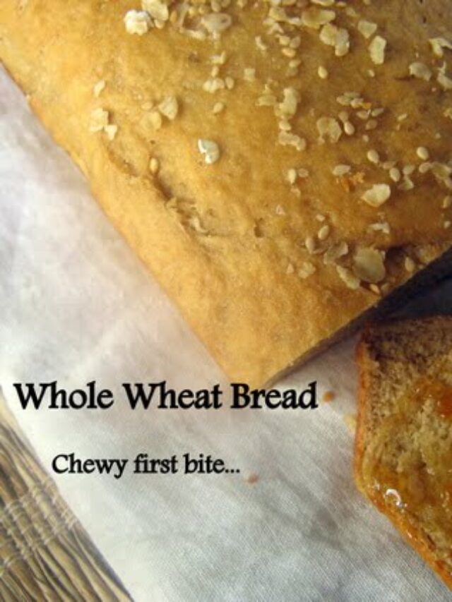 Freshly baked whole wheat bread loaf on a wooden cutting board