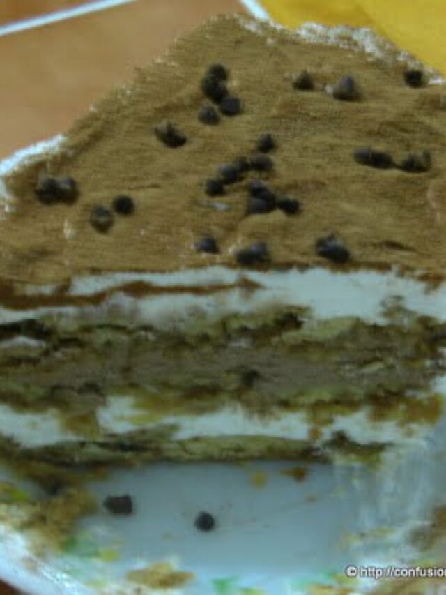 Close-up of a layered eggless tiramisu with a dusting of cocoa powder