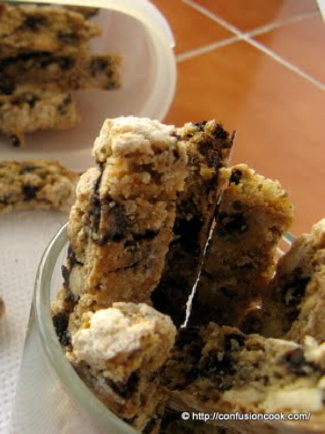 Freshly baked eggless cappuccino biscotti arranged on a wooden cutting board