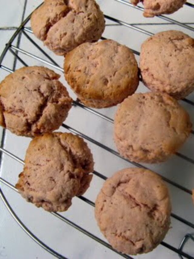 Freshly baked strawberry scones with a golden crust on a cooling rack