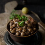 Close-up of a bowl of easy chana masala garnished with fresh coriander leaves