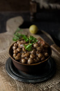 Close-up of a bowl of easy chana masala garnished with fresh coriander leaves