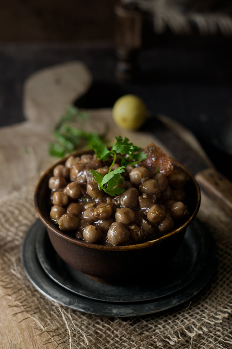 Close-up of a bowl of easy chana masala garnished with fresh coriander leaves