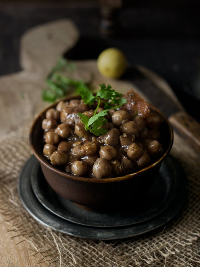 Close-up of a bowl of easy chana masala garnished with fresh coriander leaves