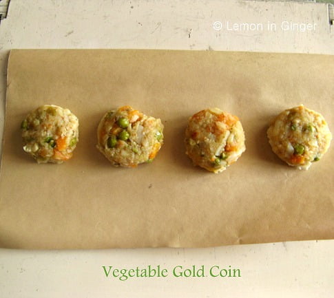 Golden-brown Veg Gold Coins arranged on a platter with garnished cheese
