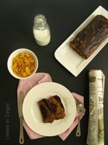 Freshly baked marbled banana bread loaf sliced on wooden board
