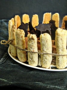 Eggless Tiramisu Charlotte decorated on a plate with a ribbon tied around it