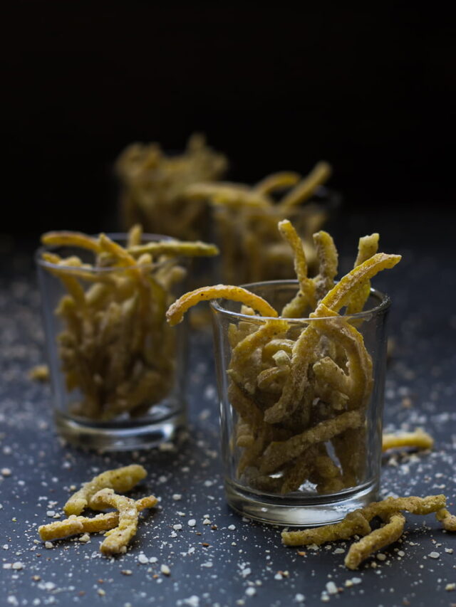 Candied orange and lemon peels drying on a wire rack