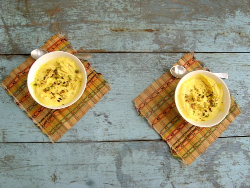 Kesar Shrikhand with saffron and almond slices served in a traditional Indian bowl