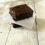 A slice of brownie showing the blend of chocolate and orange flavors with visible zest
