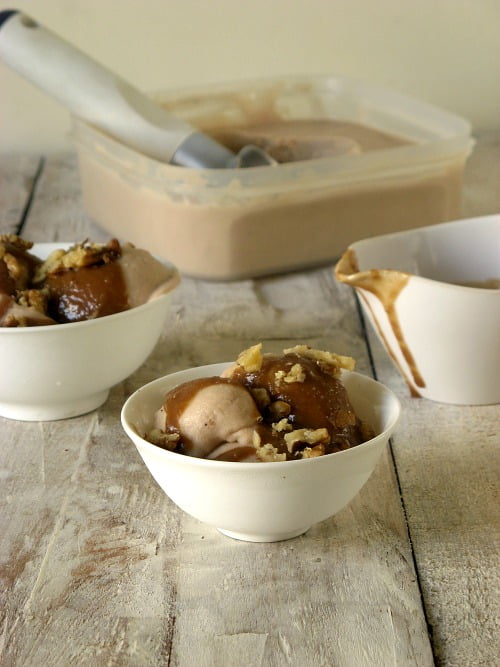 Overhead shot of roasted banana ice cream scoops with cookie crumbs