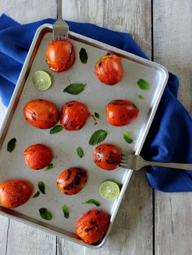 Blanched tomatoes displayed in a tray for peeling
