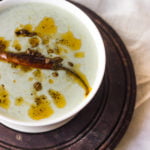 Bathua raita garnished with red chili powder and fresh coriander