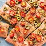 Close-up of beetroot focaccia with vibrant pink hue and herb topping