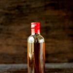 Small glass bottle of homemade vanilla extract with vanilla pods