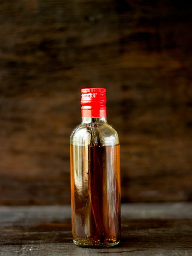 Small glass bottle of homemade vanilla extract with vanilla pods