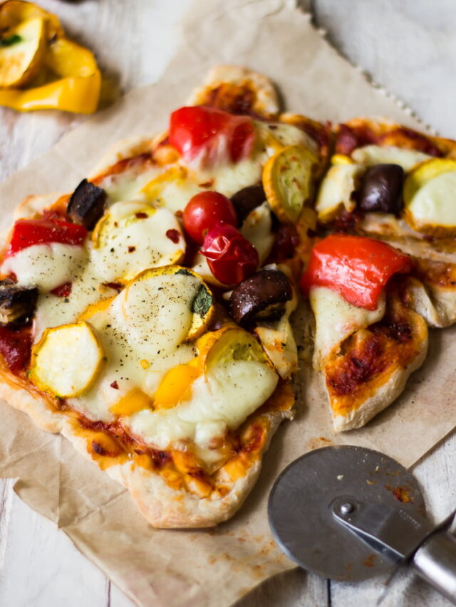 Roasted vegetable pizza with colorful toppings fresh out of the oven