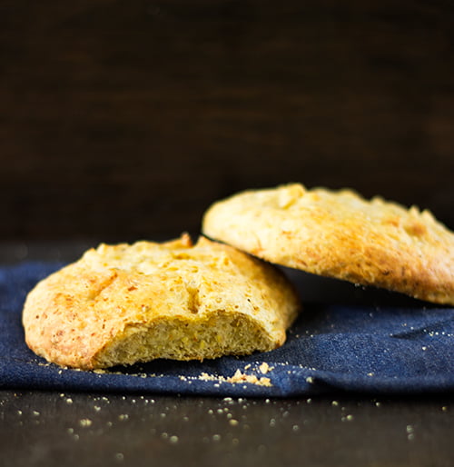 Healthy Zucchini Bread served on a wooden board with a slice ready to eat
