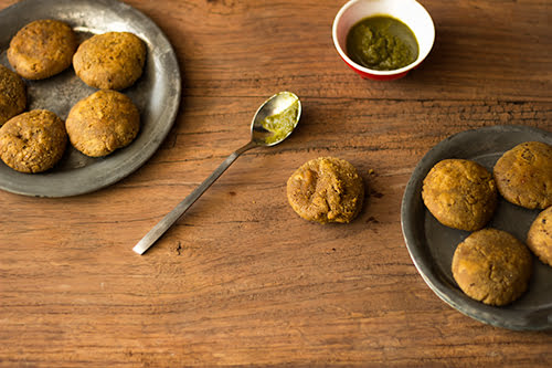 Golden-brown Chana Dal ke Kebab served on a white plate with mint chutney