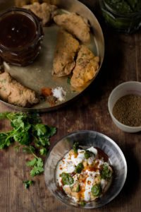 Overhead shot of Dahi Bhalla served with colorful garnishes