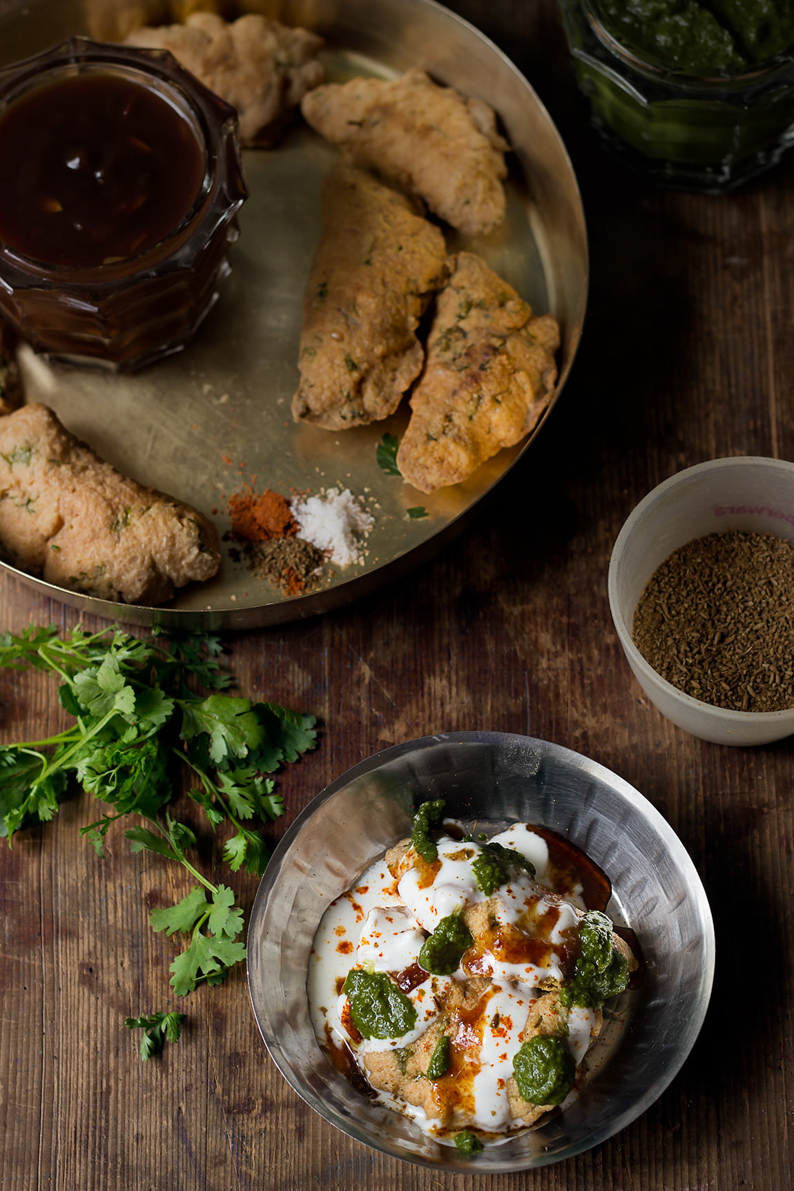 Overhead shot of Dahi Bhalla served with colorful garnishes