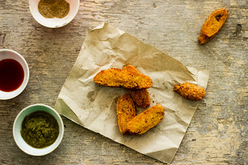 Close-up shot of Kalmi Vada with a side of garlic chutney