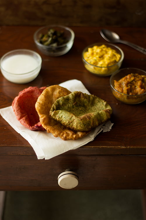 Close up view of palak and beetroot puris