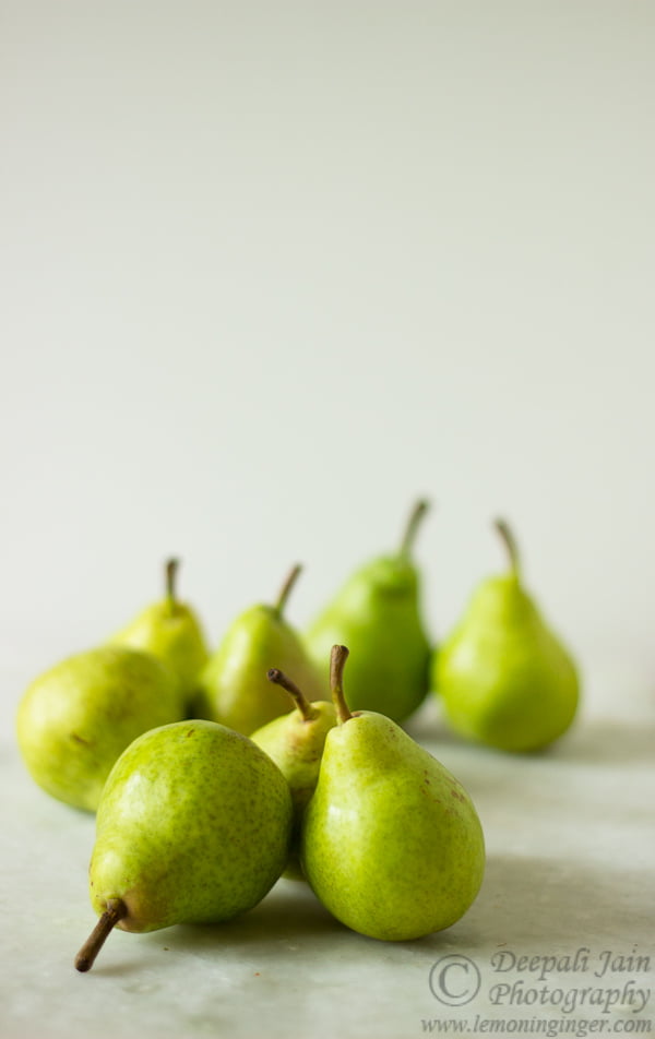 Ingredients for poached pears including sugar, cinnamon, and white wine